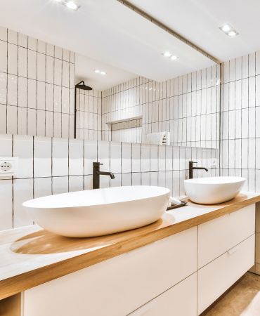 Tiled bathroom interior with twin basins
